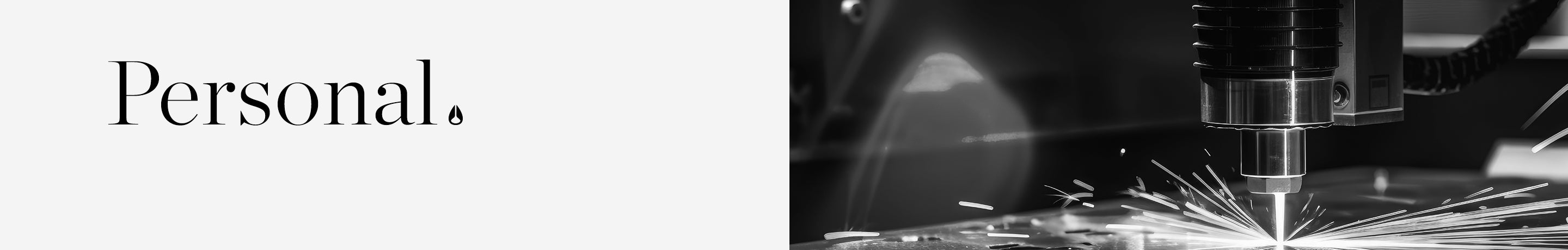 Black and white image of the word "Personal." next to a laser engraving machine creating sparks.